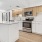 a kitchen with a large island and white cabinets